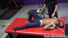 ”Kaden Roads enjoys slapping the captive with a flogger before playing with his c”