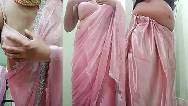 Indian Gay Crossdresser Gaurisissy Pressing and Playing with Her Big Boobs Looking in Pink Saree Looking Like a Housewife