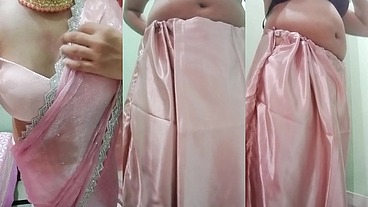 Indian Gay Crossdresser Gaurisissy Pressing and Playing with Her Big Boobs Looking in Pink Saree Looking Like a Housewife