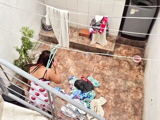 The neighbour is watched washing garments by her neighbour
