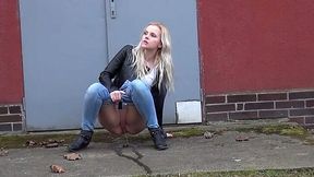 Squating down kinky amateur blonde pulls down jeans to pee outdoors