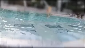 Teen girl fingers her pussy in public pool, exposing herself to strangers