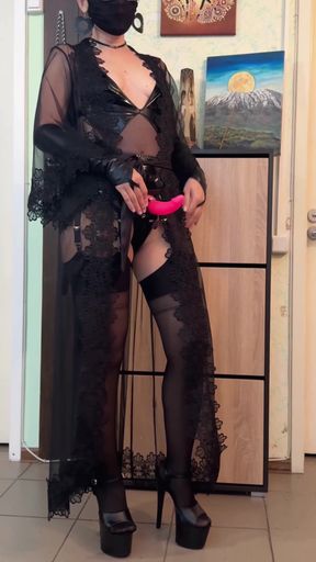 Curvy mistress stands alone in a sultry pose