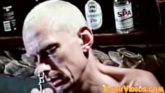 Vintage gay fetish scene with inked submissive and dominant master