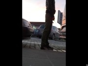 A quick piss stop behind a car