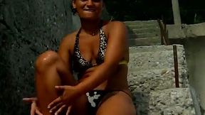 Beautiful brunette beach girl in bikini posing on cam