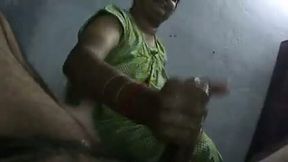 Mature and skillful Indian housewife strokes oiled up cock