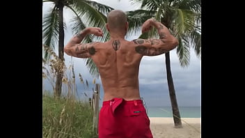 FLEXING BACK AT THE BEACH