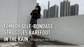 Femboy struggles barefoot in the rain on a rooftop while self-bondage