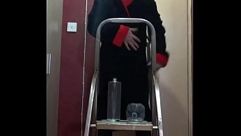 crossdressing bisexual sissy loves the taste of his own piss as he stands on a ladder pissing in a bottle