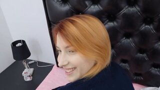 Ginger with a skinny figure is sucking on a sex toy