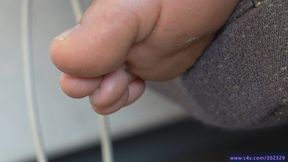 Dirty foot fetish admiration, beauty barefeet sole with pieces of dirt and sweaty on seat, close-up feet fetish.