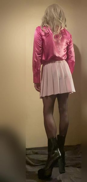 Young cute sissy in pink satin blouse and mini skirt