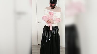Putting on pink frilly latex blouse over long rubber skirt, maid stockings, transparent panties, layers