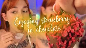 Enjoying strawberry in chocolate