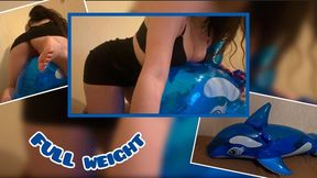 Mistress Mersiiik presses down with all her weight on the inflatable whale, sits on it, rubs, steps, stands on one leg, the whale is very heavy, sexy ass