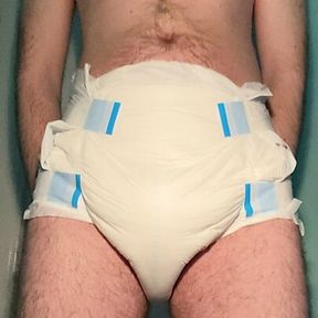 Diaper boy is peeing in a fresh diaper