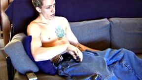 Shane relaxes on the sofa, while watching a porn video and gets totally into himself. He works his lubed up cock with determination and pumps out a big cum gusher.