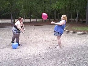 BBW gals play volley ball with balloons