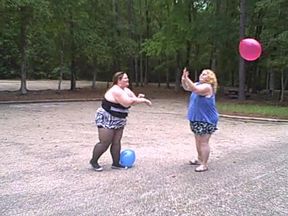 BBW gals play volley ball with balloons