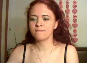 Feisty redhead babe poses for camera wearing black bra and tiny thongs