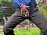 Suited man is playing with his mancunt in public