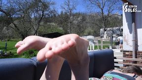 Flip flops and long toes relax on terrace