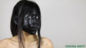 Black Asian mamba all covered in a black paint sucks dildo
