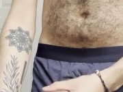hairy chest hung guy through the fly of his boxers blows a huge load into cup