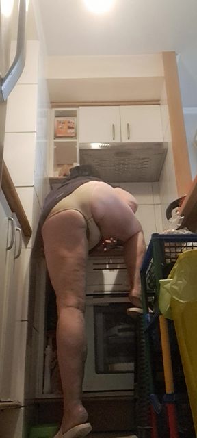 in the kitchen, relaxed, supported on her back