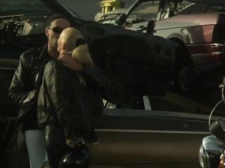 This ugly junkyard was filled with ancient automobiles, necessitating their engagement in raunchy activity on one.