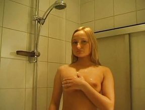 Blonde beauty is pleasuring herself in the bathroom