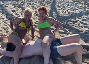 Smothering femdoms defeating male on the beach