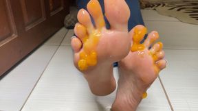 spreading mango jelly on feet