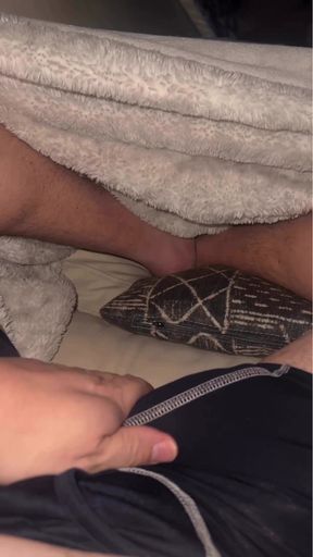 cock stroking with my feet peeking around the covers