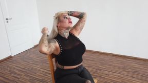 Tattooed blonde MILF combing her hair.
