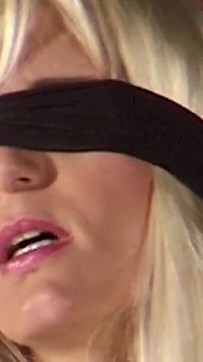 Mature Dominatrix Oversees Masked Man with Bound Blonde