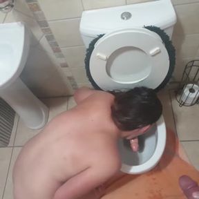 Human toilet teen sucking and licking piss covered dildo in toilet