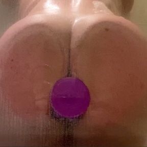 Big bubble butt fucking dildo against glass