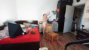 An amateur woman cleans the house with the vacuum cleaner. Sexy mom has fun with naked roses