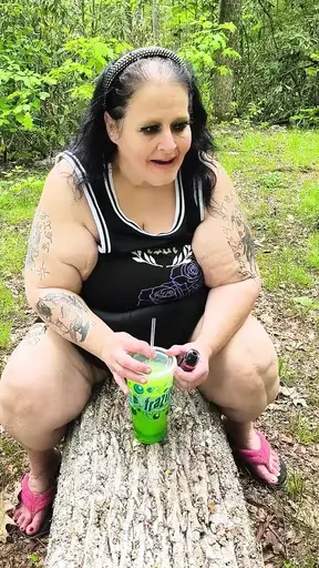 Woodland MILF sucks on a straw and squirts on a tree