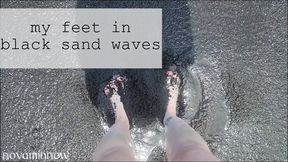 my feet in black sand waves