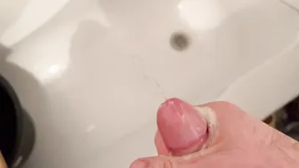 Solo twink strokes his big uncut cock, pisses and shoots a slow-motion cumshot close up