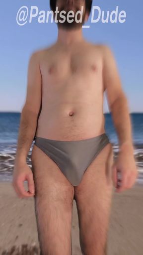 Slim swimsuit model struggles with a malfunctioning suit while trying