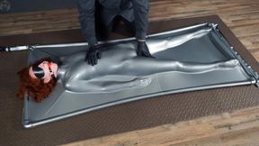 Intense tickling in a grey vacuum bed using a red gag and blindfold
