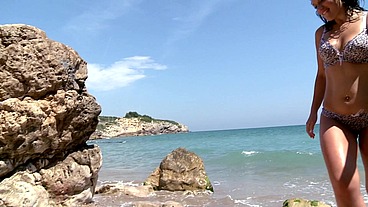 A brunette gets aroused on the beach and gets fucked in the pussy and ass during a double penetration.