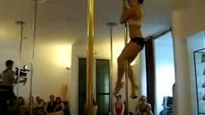 Tasty looking brunette chic moves seductively on a pole