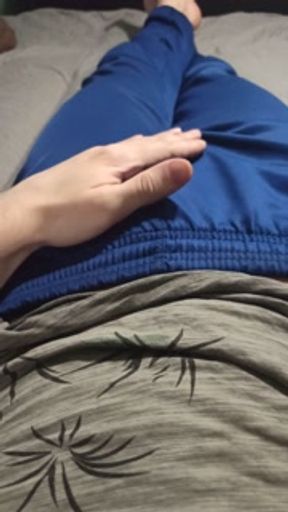 A guy in blue sweatpants rubs his bulge