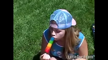 Cute Little April Outdoors Sucking A Popsicle