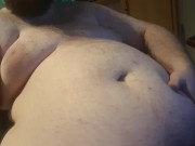 Chubby plays with his bellybutton